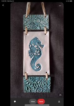 an image of a tile with a seahorse on it