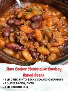 a close up of a bowl of food with beans and meat in it on a table