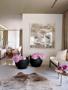 three different rooms with white walls and pink flowers in vases on the floor, one is