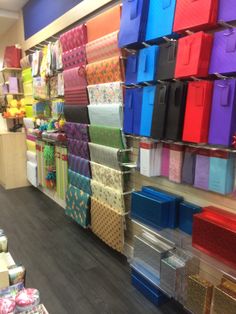 there are many colorful boxes on the wall in this store that is filled with items