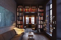 a living room filled with furniture and bookshelves