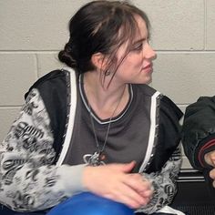 two people sitting next to each other in front of a blue ball on a table