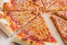 a sliced pizza sitting on top of a wooden cutting board