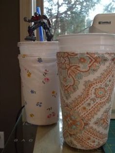 two coffee cups sitting next to each other on a counter