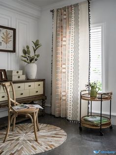 a living room filled with furniture and a window covered in sheer drapes next to a potted plant