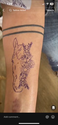 a tattoo on the arm of a woman with flowers and a horse's head