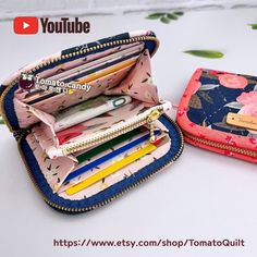 two small wallets sitting next to each other on a table