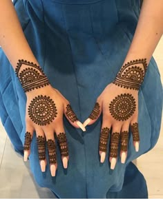 two hands with henna designs on them