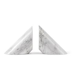 two white marble bookends sitting side by side on top of each other in front of a white background