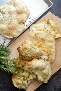 some bread with herbs on a cutting board