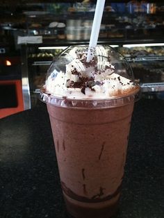 there is a chocolate drink with whipped cream in the top and toppings on it