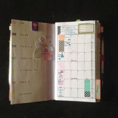 an open planner book sitting on top of a table