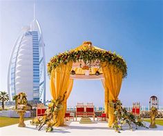 an outdoor wedding setup in front of the burj