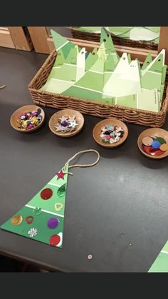 some paper plates are sitting on a table and there is a christmas tree in front of them