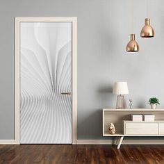 an open door in a room with wooden flooring and white wall art on the walls