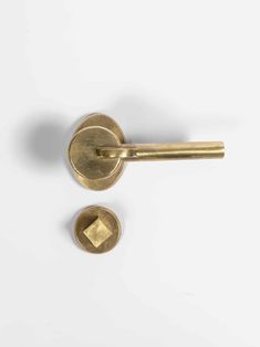 two brass door knobs on a white background