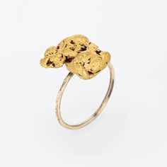 Originally an antique Victorian era stick pin (circa 1880s to 1900s), the natural gold nugget is crafted in 14 karat yellow gold.  The ring is mounted with the original stick pin. Our jeweller rounded the stick pin into a slim band for the finger. The natural mined from the earth gold nugget is substantial in size, measuring 15mm x 13mm (0.59 x 0.15 inches). The nugget has a lovely rich buttery patina with a softness to the touch.    The ring is in very good condition. We have not cleaned it in Heirloom 14k Gold Nugget Ring, Heirloom 14k Gold Jewelry, Yellow Gold Nugget Brass Jewelry, Gold Hammered Nugget Rings, 14k Yellow Gold Nugget Jewelry, Heirloom Gold Nugget Ring, Alligator Ring, Wedding Ring Guard, Gold Nugget Ring