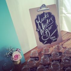 there is a sign that says make a wish bar with mason jars in front of it