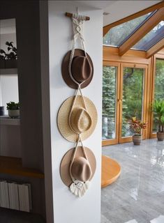 three hats are hanging on the wall