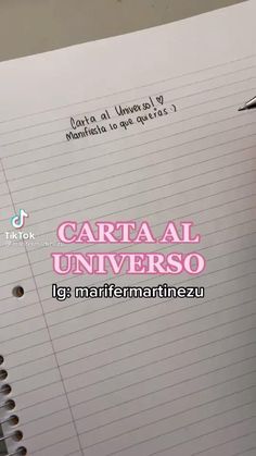 a notepad with writing on it and a pen in front of the page that says carta al universo