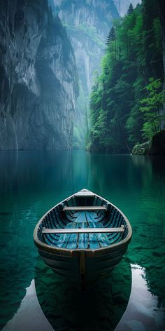 a boat floating on top of a lake surrounded by mountains