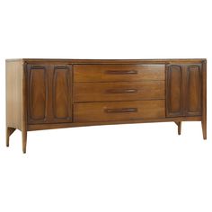 a wooden sideboard with three drawers and two doors