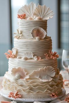 a wedding cake with seashells on it