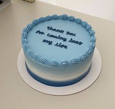 a blue cake sitting on top of a table