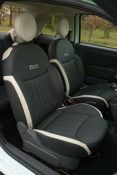 the interior of a car with two black and white seats