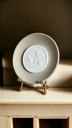 a white plate sitting on top of a wooden shelf