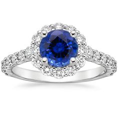 a blue sapphire and diamond ring with white diamonds on the band, set in 18k white gold