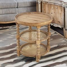 a wooden table sitting on top of a rug next to a couch