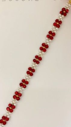 a red and white beaded bracelet with pearls