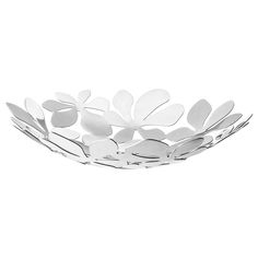 a white bowl filled with flowers on top of a table