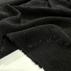 black and white photograph of an unbuttoned piece of cloth