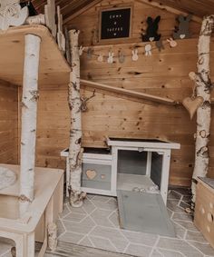 the interior of a cabin with wooden walls and flooring