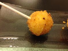 two fried food items on a plate with toothpicks sticking out of the top