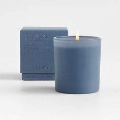 a blue candle sitting next to a box