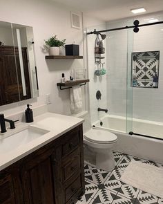 a bathroom with black and white floor tiles