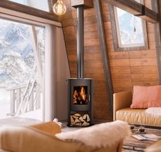 a living room filled with furniture and a fire place in the middle of a room