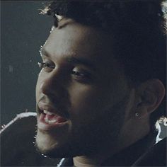 a close up of a person with his mouth open and teeth slightly closed, in front of a black background