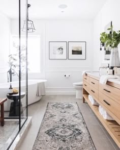 a bathroom with a large rug on the floor