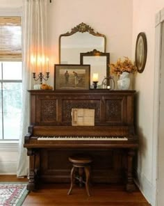 an old piano in the corner of a living room with a mirror on the wall