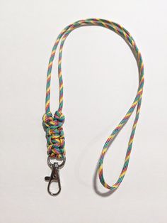 "Minimalist Paracord or Parachute Cord ID Lanyard I made this with a Multi-Colored parachute cord (Paracord 550) and it is knotted at the bottom by the id clip. The ends are melted into the back of the knots. The Overall Length of the Lanyard is about 18\". (From the back of the neck to the end of the Lobster Claw ID clip) Paracord 550 is: 4mm in diameter 7 inner strands Polyester Choose the break away option for the pull apart plastic clasp to be added to the back of the neck area of the lanyar Crafternoon Ideas, Lanyard Knot, Semper Paratus, Mens Choker Necklace, Paracord Accessories, Paracord Lanyard, Cute Lanyards, Paracord Knots, Id Lanyard