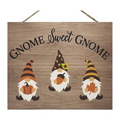 three gnomes are standing in front of a wooden sign that says gnome sweet gnome