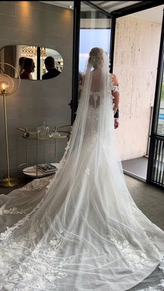 the bride is getting ready to walk down the aisle in her wedding dress and veil