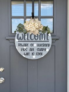 a welcome sign is hanging on the front door