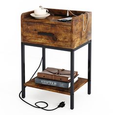 a small wooden table with a book on it and a cup of coffee next to it