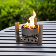 a fire pit sitting on top of a metal table