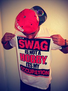 a man wearing a red hat and t - shirt with the words swag is not a hobby, it's my separation